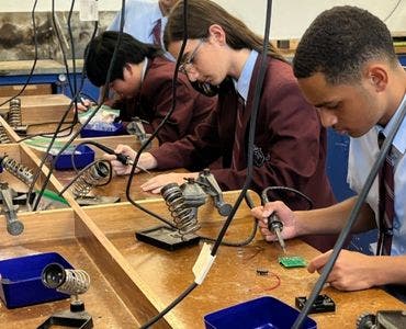 Students using soldering irons
