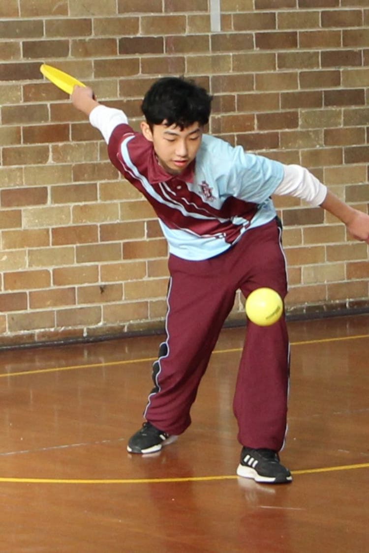 Student playing pickle ball