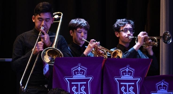 Three boys playing instruments
